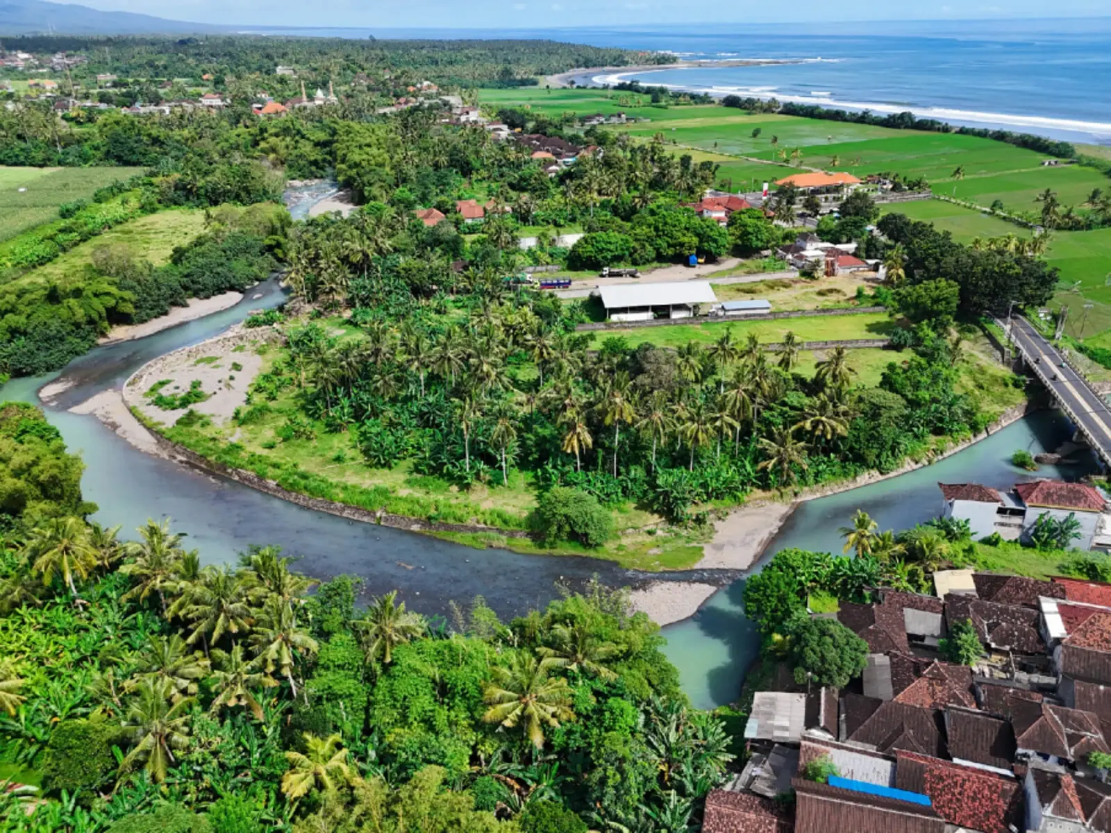 MEDEWI 11-3_1600x1200_compressed Drone panorama of Medewi river bend and green landscape leading to ocean surf breaks in West Bali