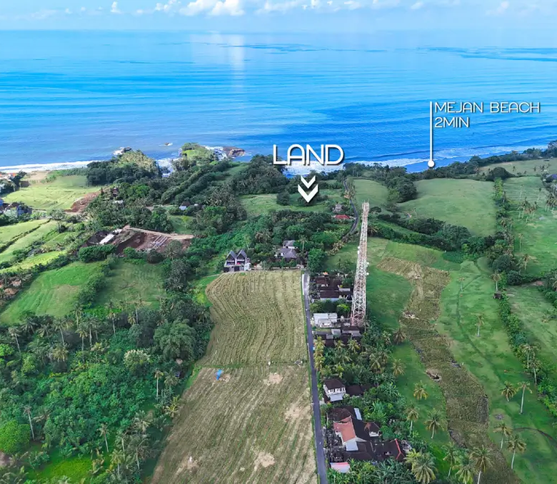 Drone panorama of Mejan Bali land plot 2 minutes from the beach, overlooking rice fields, coastline, and ocean waves