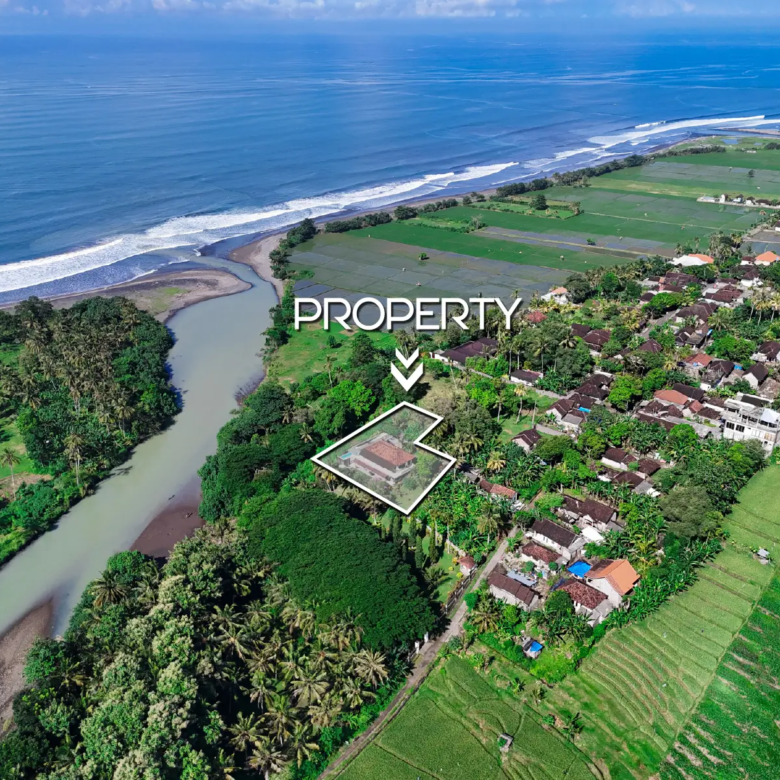 Aerial view of riverfront property in Pulukan with ocean and rice field landscape
