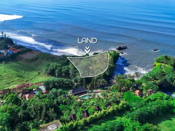 Aerial view of cliffside land for sale in Balian, Bali overlooking the ocean with lush tropical greenery.