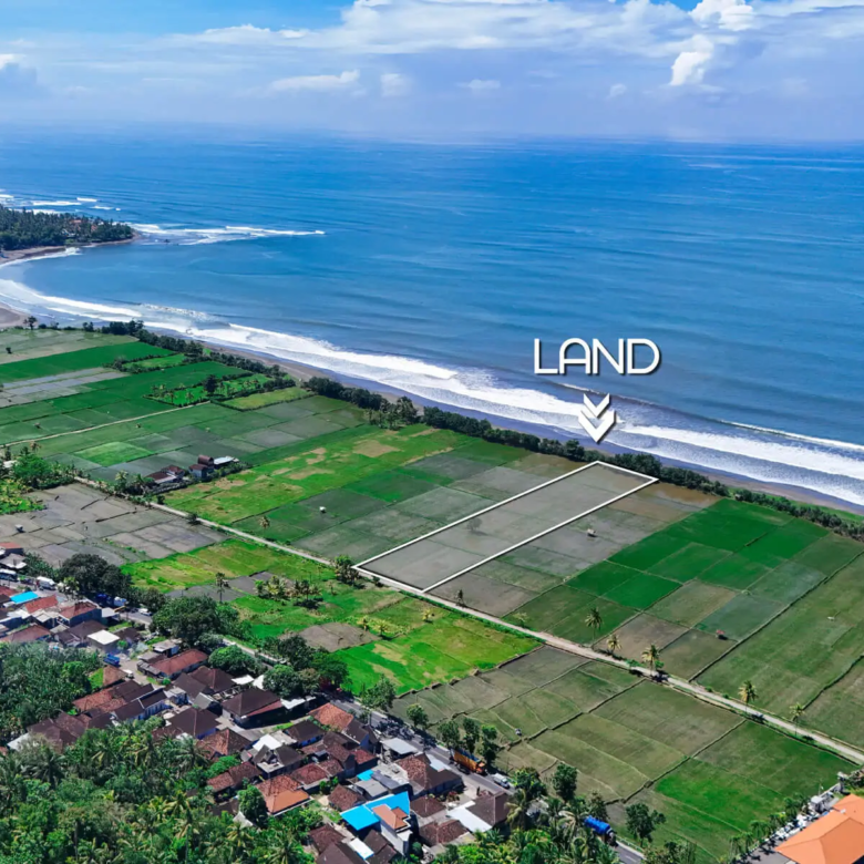 Aerial view of beachfront land in Pulukan, West Bali, showing rice fields and ocean waves with land boundary marked near Pulukan surf beach.