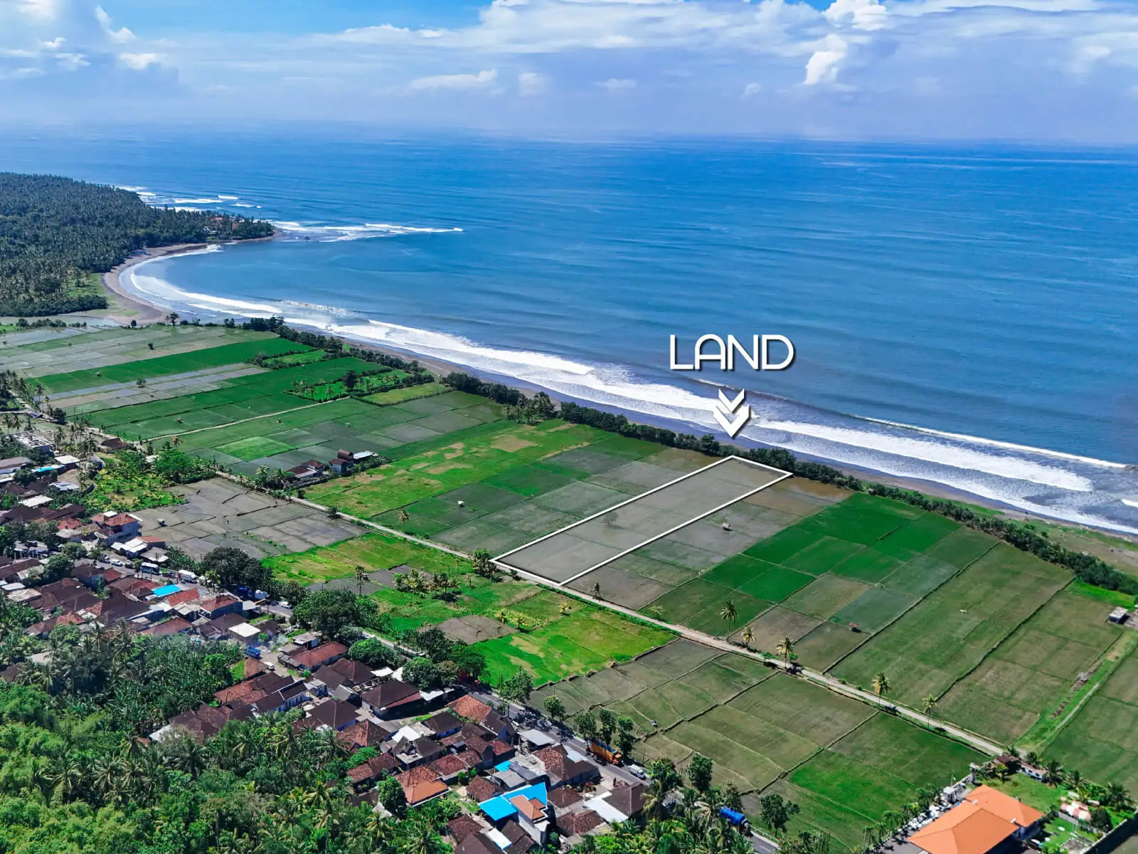 Aerial view of beachfront land in Pulukan, West Bali, showing rice fields and ocean waves with land boundary marked near Pulukan surf beach.