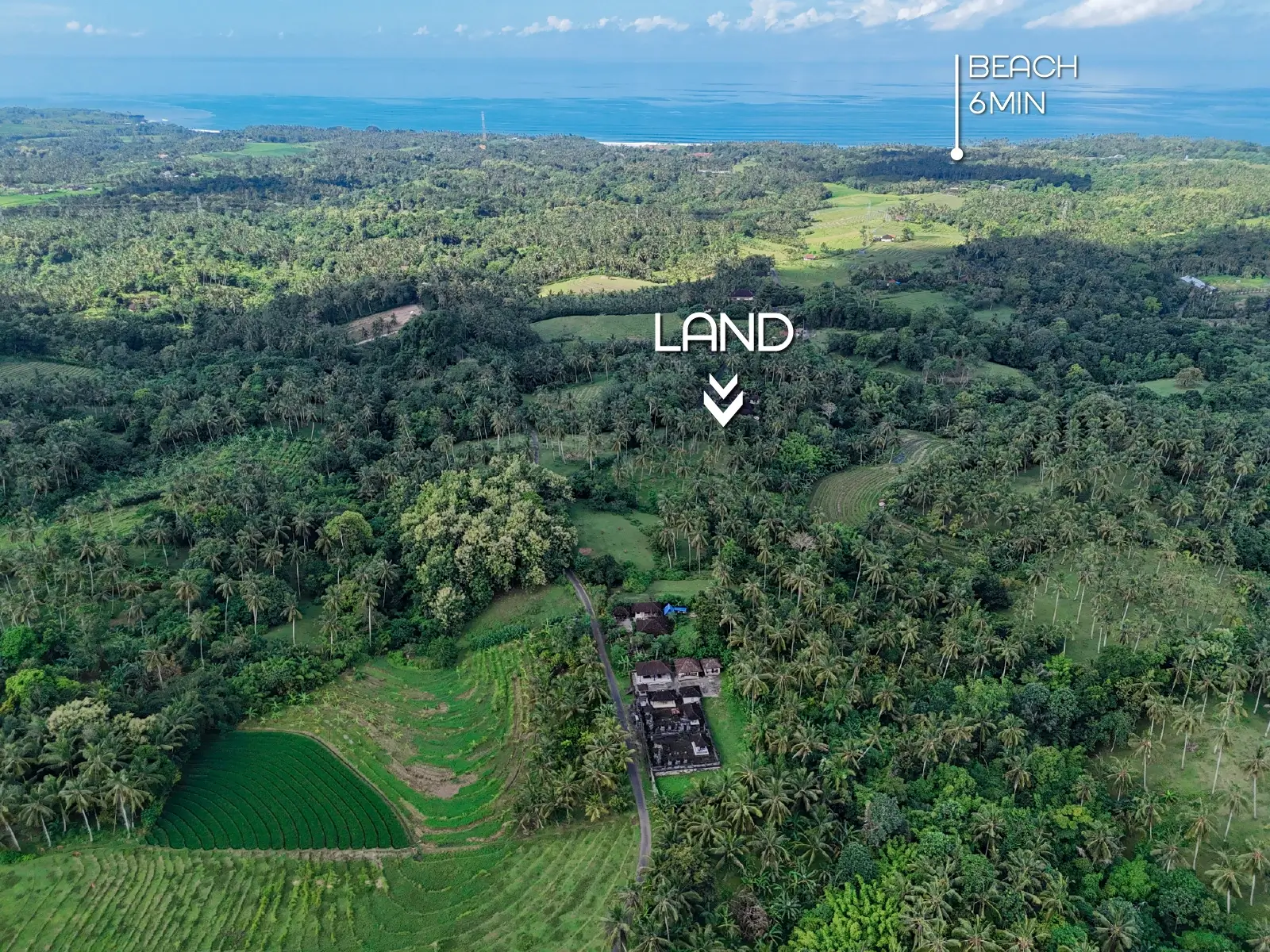 Aerial view of West Bali showing lush green hills, ocean in the background, and the marked land for sale located just 6 minutes from the beach