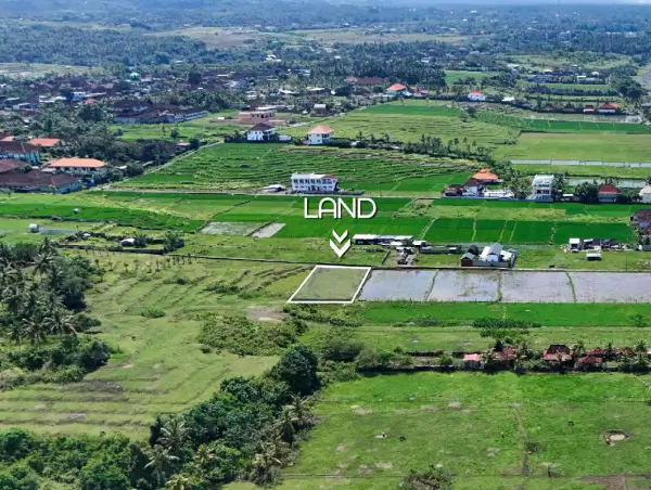 Aerial view of a land plot for sale in West Bali, surrounded by lush rice fields and rural village landscapes
