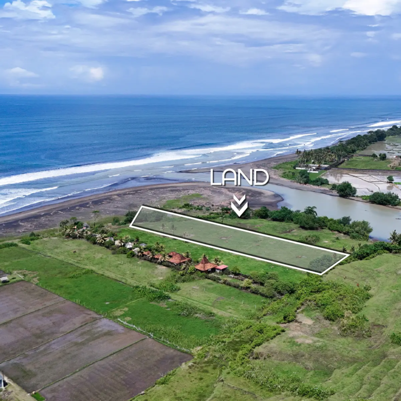 Aerial view of beachfront land for sale in West Bali, outlined along the coastline with ocean waves and river estuary in the background
