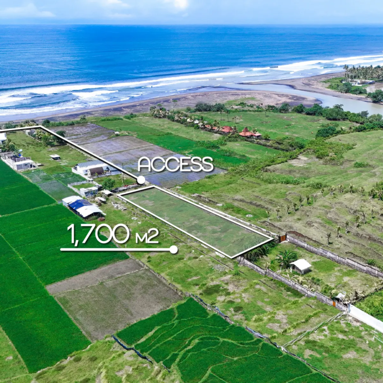Aerial view marking a 1,700 m² land plot in West Bali with private access road, rice field surroundings, and ocean views