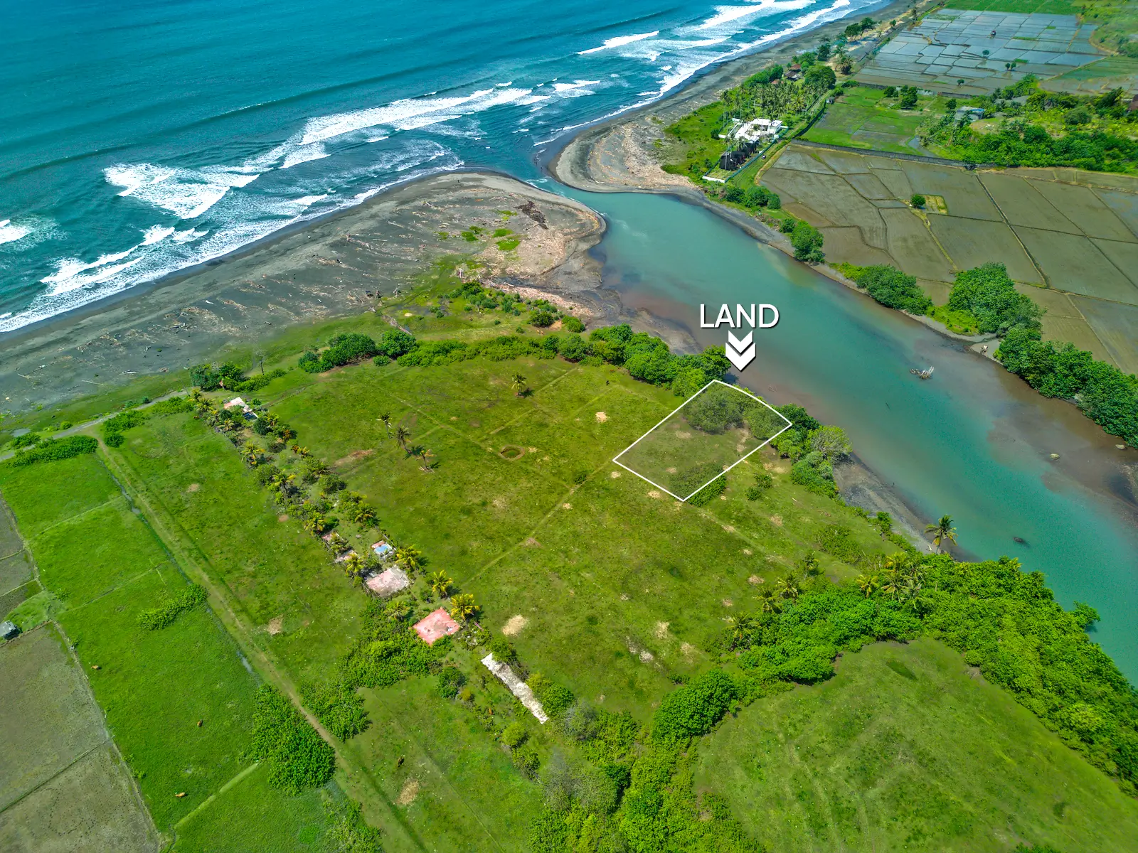 Top-down drone image of a 1,000 m² lagoon-front land plot in West Bali, showing private access road, curved river boundary, and surrounding greenery.