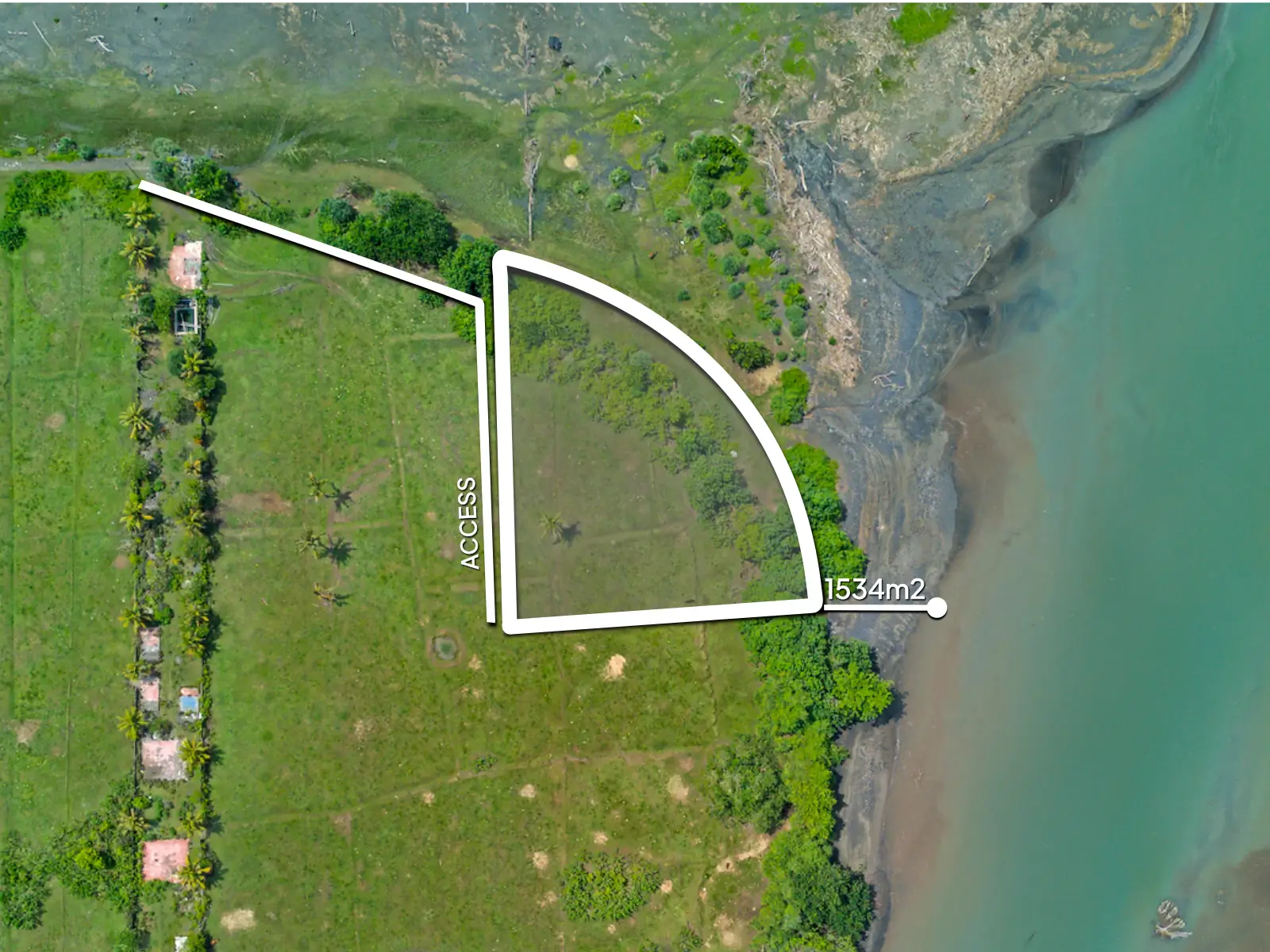 Top-down drone image of a 1,534 m² riverfront land plot in West Bali, showing curved beachfront boundary, private access road, and turquoise river frontage.