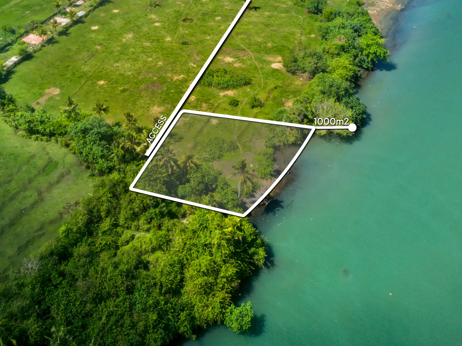 yehsumbul5-5 redo Top-down drone image of a 1,000 m² beachfront lagoon-front land plot in West Bali, showing private access road, curved river boundary, and flat land ready for development.