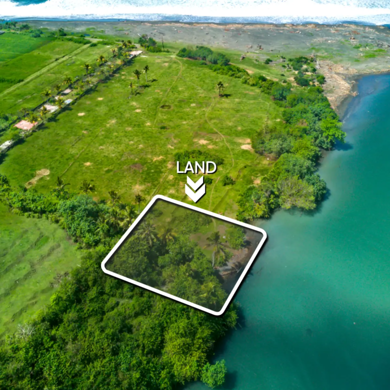Top-down drone image of a 1,000 m² beachfront lagoon-front land plot in West Bali, showing private access road, curved river boundary, and flat land ready for development.